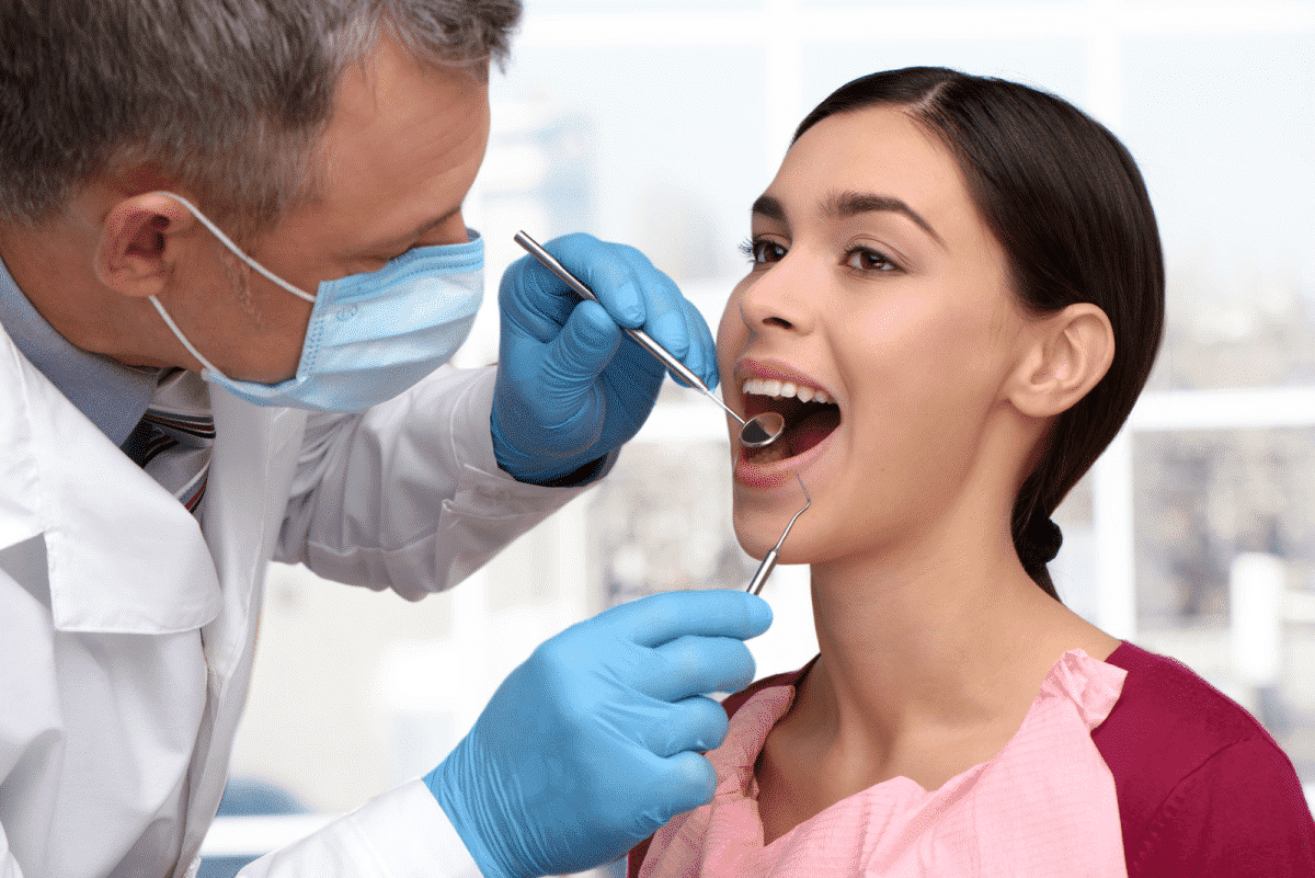 about dental tori | Dental Expert examining a woman's Teeth